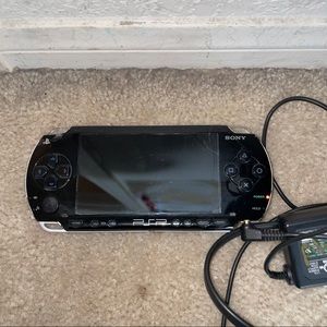 PlayStation Portable with case, games, and charger